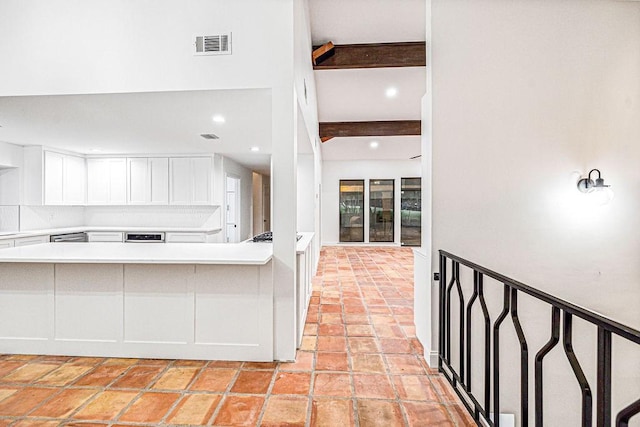 kitchen with beamed ceiling and white cabinets