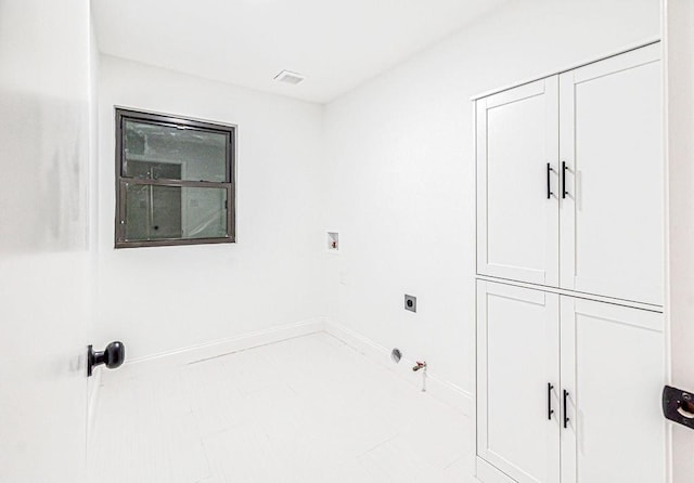 clothes washing area with cabinets, gas dryer hookup, washer hookup, and hookup for an electric dryer