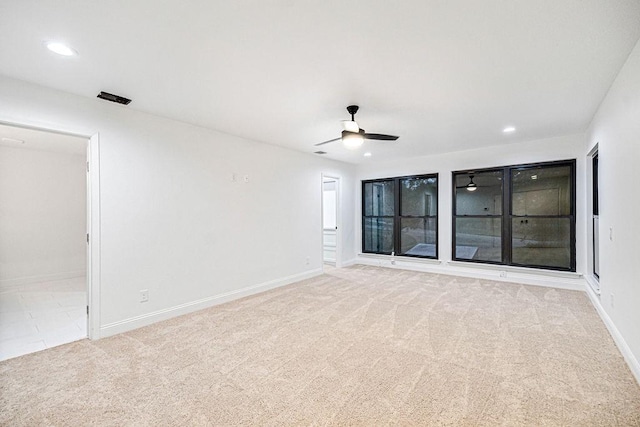 unfurnished room featuring light colored carpet and ceiling fan