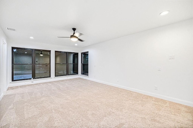 unfurnished room with ceiling fan and light colored carpet