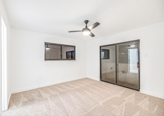 spare room with carpet flooring and ceiling fan