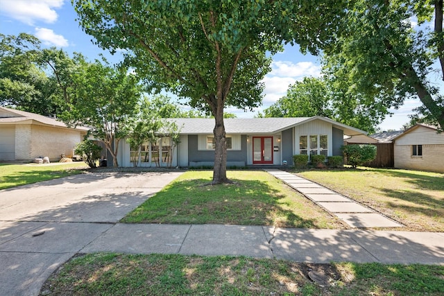 ranch-style home with french doors and a front yard