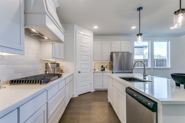 kitchen featuring custom exhaust hood, appliances with stainless steel finishes, sink, and white cabinets