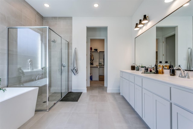 bathroom featuring vanity, tile patterned floors, and separate shower and tub