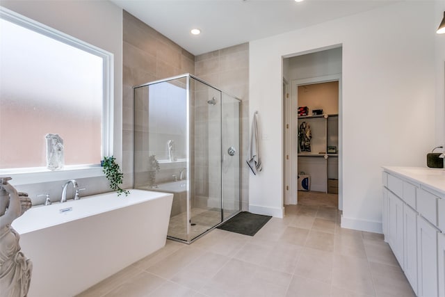 bathroom featuring vanity, tile patterned floors, and independent shower and bath