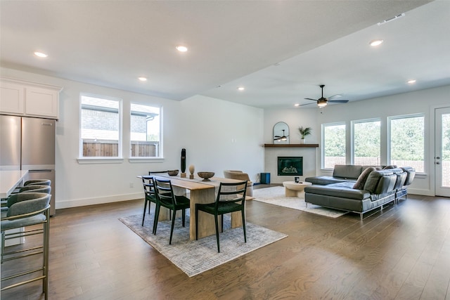 dining space featuring dark wood-type flooring and ceiling fan