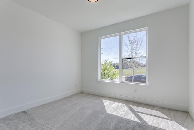 unfurnished room with light colored carpet and a healthy amount of sunlight