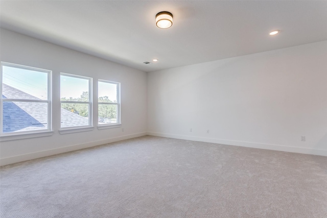 spare room with light colored carpet