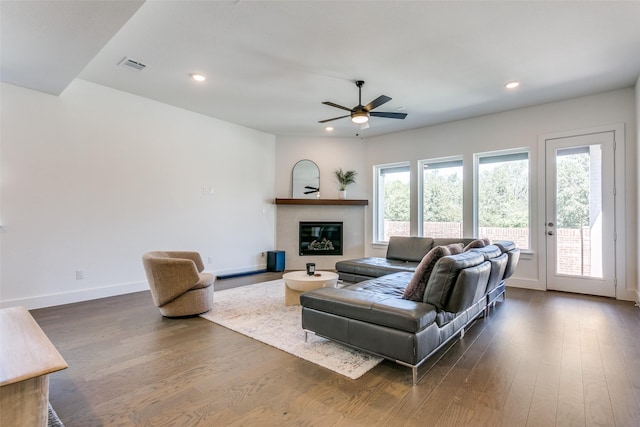 living room featuring dark hardwood / wood-style floors and ceiling fan