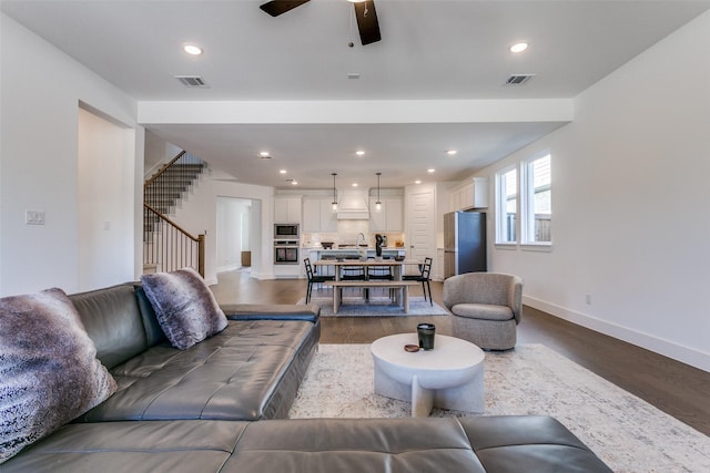 living room with sink, hardwood / wood-style floors, and ceiling fan