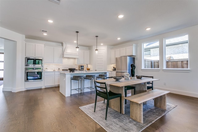 dining room with sink and dark hardwood / wood-style floors