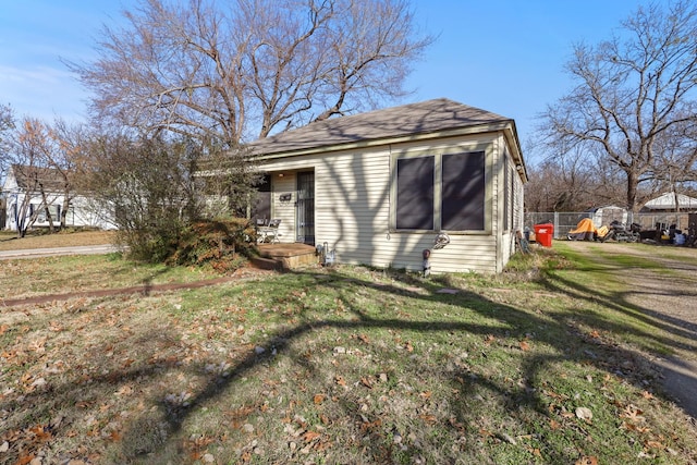 view of side of property featuring a yard