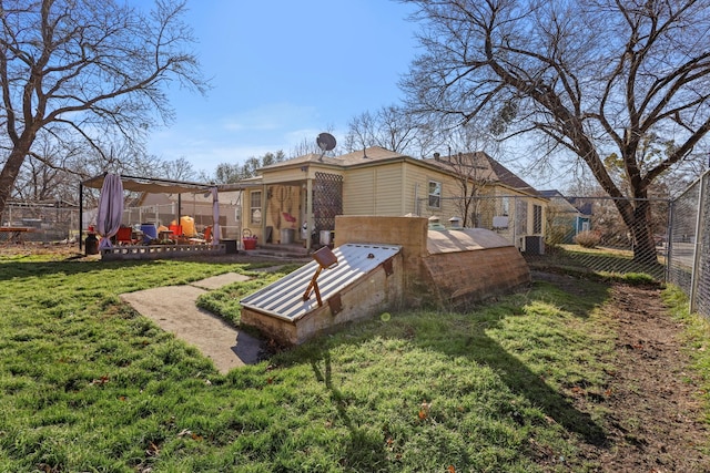 rear view of property with a yard