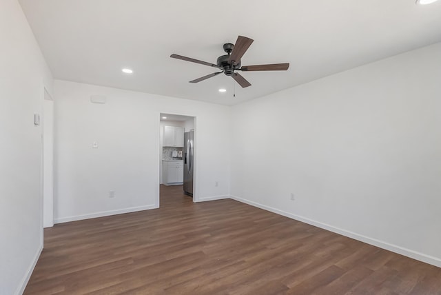 unfurnished room with ceiling fan and dark hardwood / wood-style floors