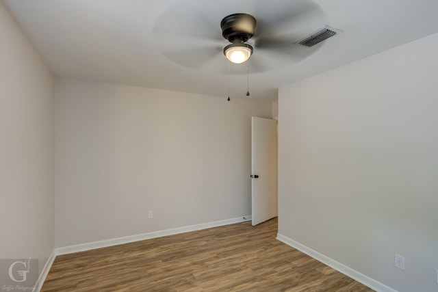 spare room featuring wood-type flooring and ceiling fan