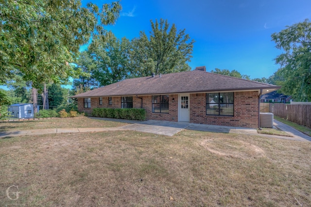 ranch-style house with a shed, cooling unit, a patio area, and a front yard