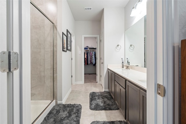 bathroom featuring vanity, an enclosed shower, and tile patterned flooring