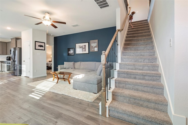 living room with hardwood / wood-style floors and ceiling fan