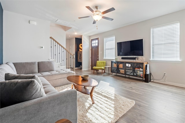 living room featuring ceiling fan and light hardwood / wood-style floors