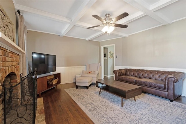 living room featuring coffered ceiling, a brick fireplace, dark hardwood / wood-style floors, beamed ceiling, and ceiling fan