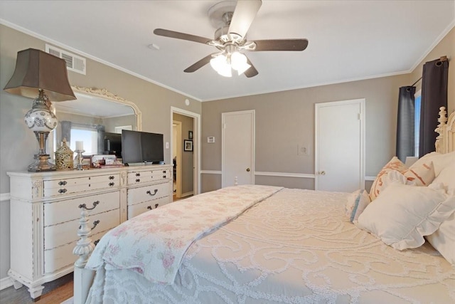 bedroom with ceiling fan, visible vents, and crown molding