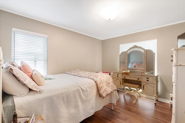 bedroom with ornamental molding and dark hardwood / wood-style flooring