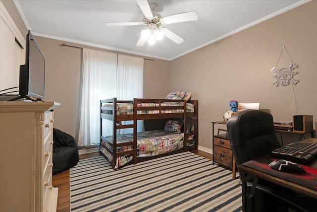 bedroom featuring ornamental molding, wood finished floors, and a ceiling fan