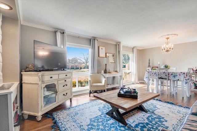 living area featuring an inviting chandelier and wood finished floors