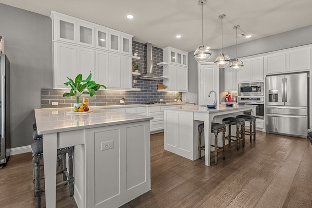 920 Windrock Ln, Prosper, TX 75078 - kitchen with stainless steel appliances, wall chimney range hood, a kitchen breakfast bar, a kitchen island with sink, and decorative backsplash