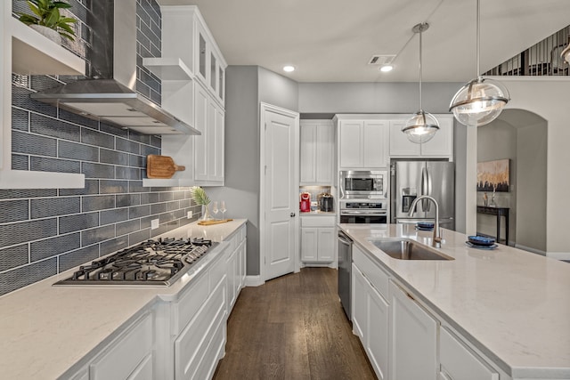 920 Windrock Ln, Prosper, TX 75078 - kitchen with appliances with stainless steel finishes, a sink, wall chimney exhaust hood, tasteful backsplash, and dark wood-style flooring
