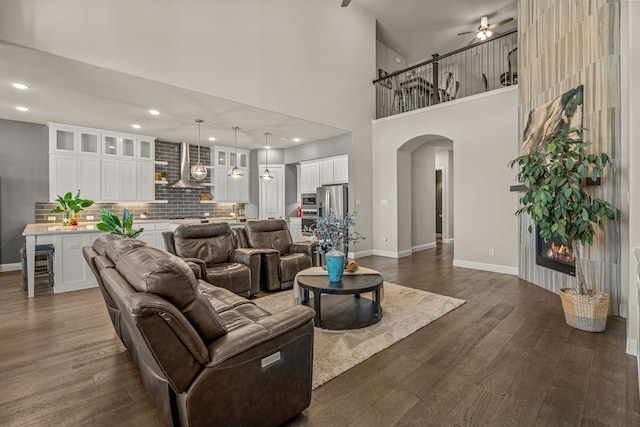 920 Windrock Ln, Prosper, TX 75078 - living room featuring arched walkways, a ceiling fan, dark wood-style floors, baseboards, and recessed lighting