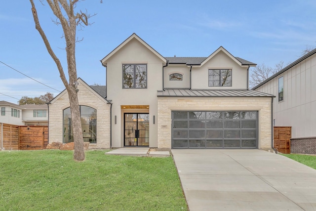 view of front of home featuring a garage and a front yard