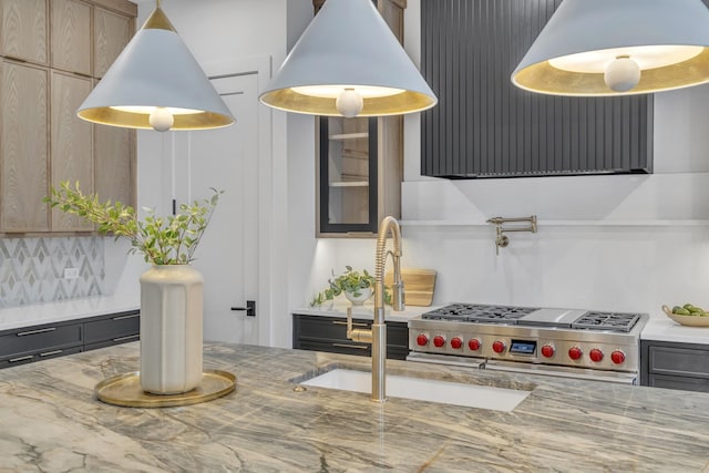 interior space with tasteful backsplash, double oven range, light stone countertops, and light brown cabinets