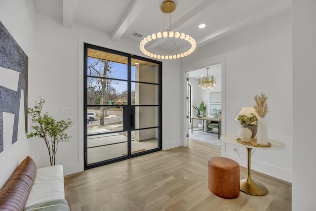 entryway featuring beam ceiling, a chandelier, and light parquet floors