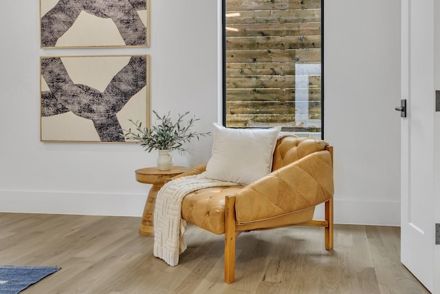 sitting room with wood-type flooring