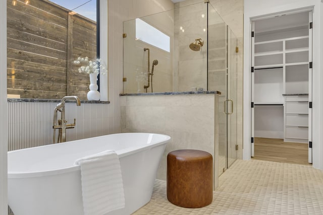 bathroom featuring tile patterned floors and separate shower and tub