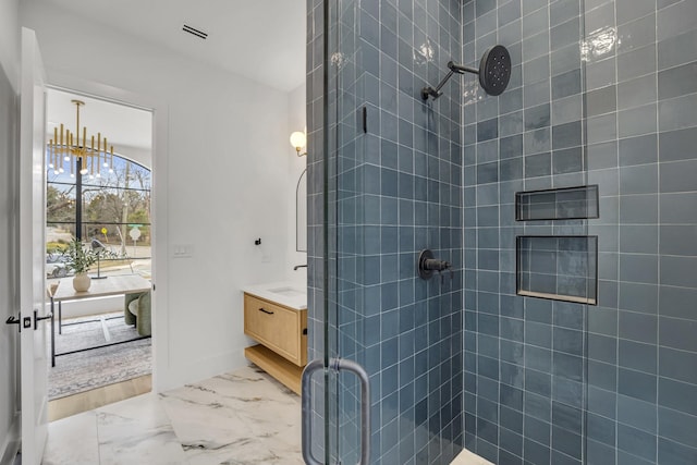 bathroom with vanity and a shower with door