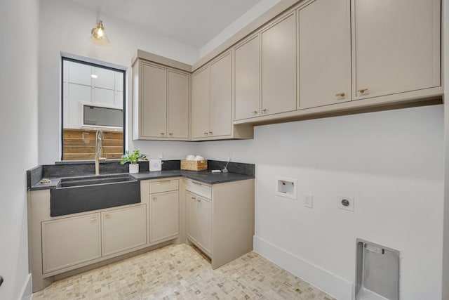 washroom featuring cabinets, electric dryer hookup, sink, and washer hookup