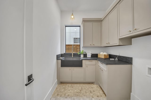 kitchen featuring gray cabinets and sink