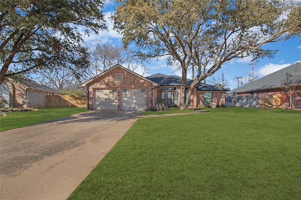 view of front of house featuring a garage and a front lawn