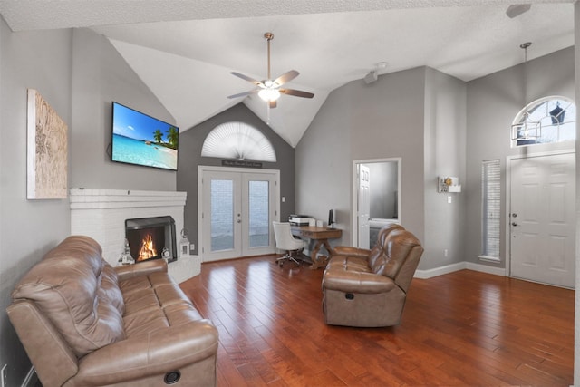 living room with plenty of natural light, dark hardwood / wood-style floors, and french doors