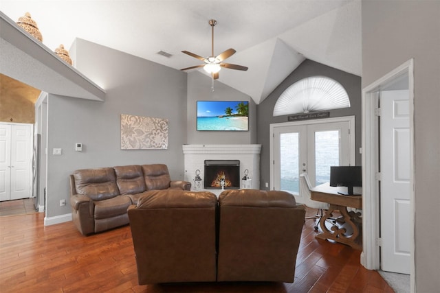 living room with french doors, lofted ceiling, dark hardwood / wood-style floors, and a brick fireplace