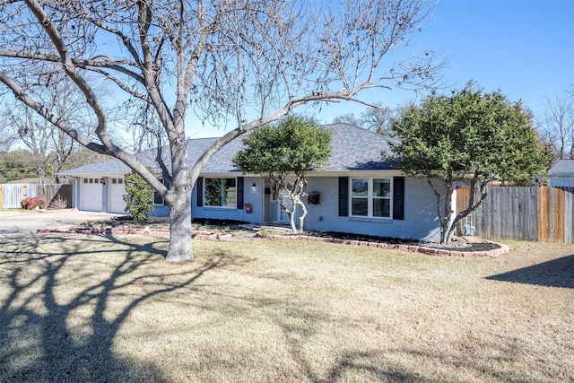 single story home featuring a garage and a front yard