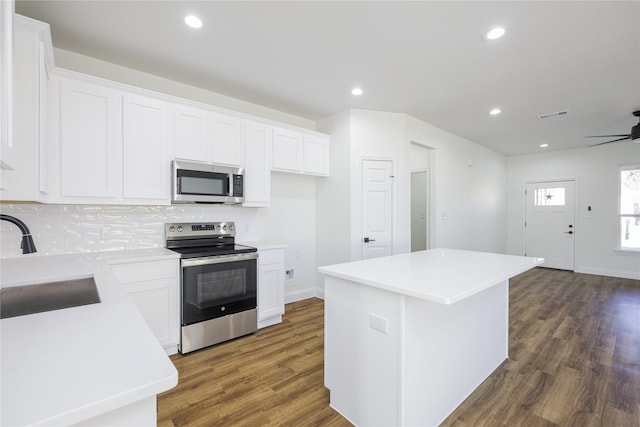 kitchen featuring white cabinetry, a center island, and appliances with stainless steel finishes