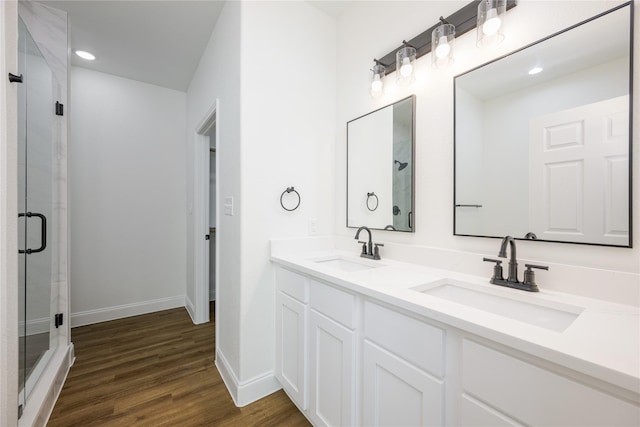 bathroom featuring walk in shower, vanity, and hardwood / wood-style floors