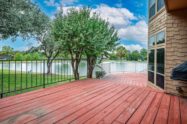 wooden deck featuring a yard and a water view