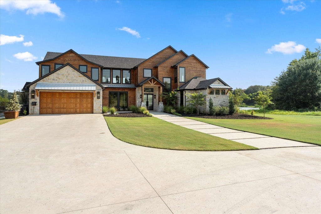 view of front of house with a garage and a front yard