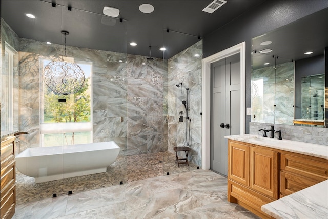 bathroom featuring vanity, separate shower and tub, and decorative backsplash