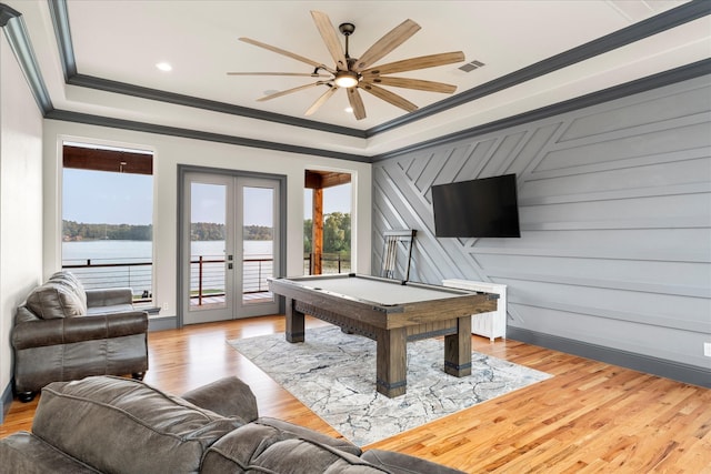 playroom featuring a water view, crown molding, light hardwood / wood-style floors, and french doors