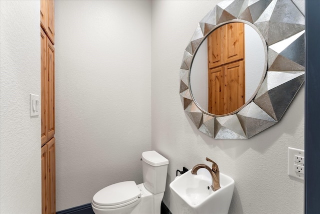 half bathroom with a sink and toilet
